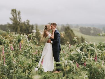Eagle Ridge Country Estate, Wedding Venue, happy bride and groom kissing in vines